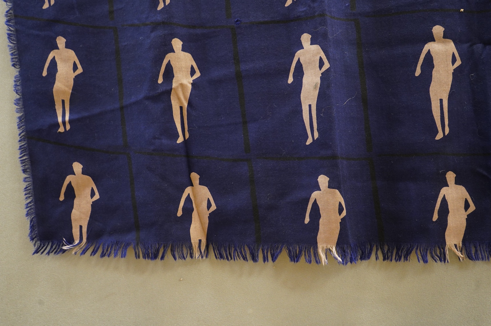 A 1983 blue wool hand printed beige cut out figures fringed - designed by Fraser Taylor of ‘The Cloth’ (RCA 1983)., 97cm x 294cm long. Condition - good